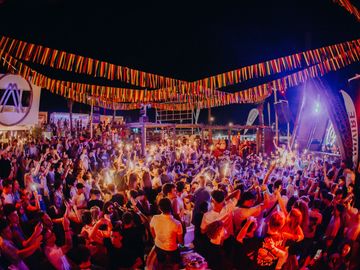 Night crowd under the lit-up flags – Nomad Beach Club, Zrce Beach