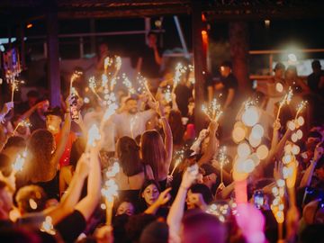 Sparklers above the dancing crowd at night – Nomad Beach Club, Zrce Beach