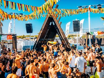 Crowd dancing in front of the tipi-shaped DJ booth – Nomad Beach Club, Zrce Beach