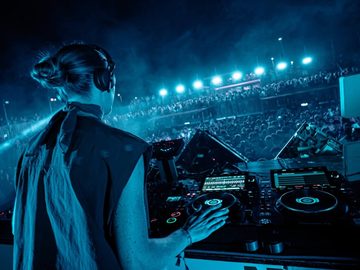 DJ at the decks under blue lights – Symbol Beach Club, Zrce Beach