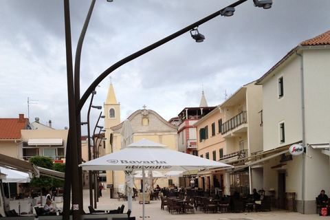 Café terraces and church on Novalja’s main square
