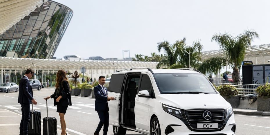 Driver loading luggage into a transfer van at the airport