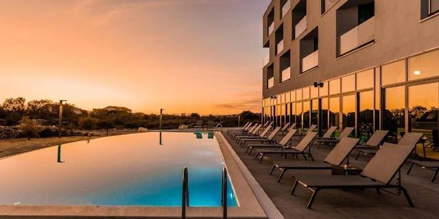 Hotel pool at sunset in Novalja, near Zrće Beach